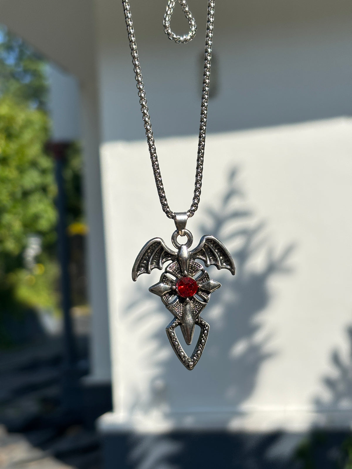Cross pendant with red stone