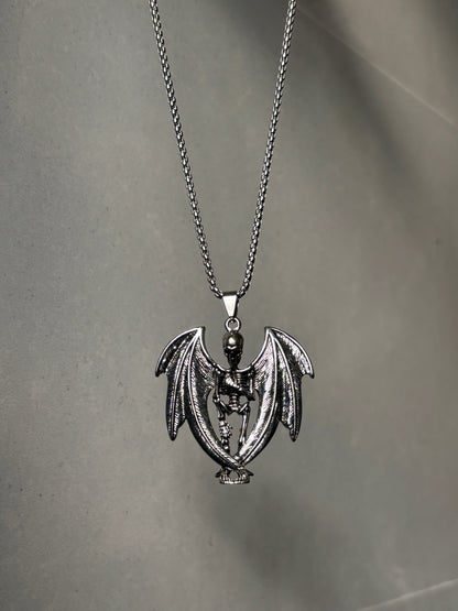 Anti-tarnish skeleton devil pendant necklace on a gray surface
