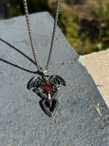 Cross pendant with red stone